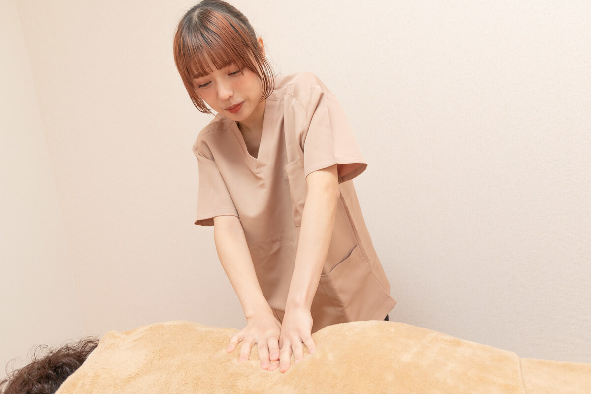 腰まわりへの整体施術を受ける女性